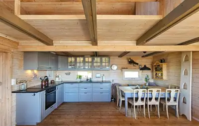 a kitchen with a table and a dining room at 5 Bedroom Stunning Home In Eggedal in Eggedal