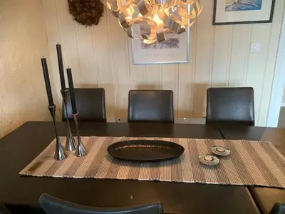a table with chairs and a plate on a table at Central on Beitostølen with walking distance to everything in Beitostøl