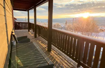 a balcony of a house with a view of the mountains at Central on Beitostølen with walking distance to everything in Beitostøl
