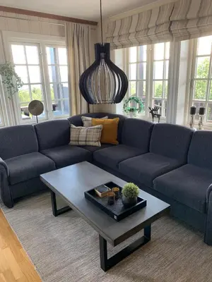 a living room with a blue couch and a coffee table at Central on Beitostølen with walking distance to everything in Beitostøl