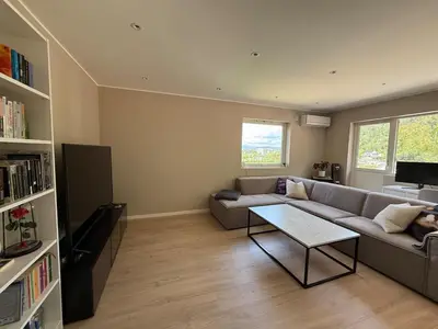 a living room with a couch and a coffee table at Moderne 3-roms nær sentrum in Bergen