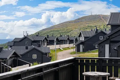 a village of houses with a hill in the background at Fagertoppen 1314B by Vacation Trysil in Trysil