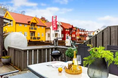 a table with a bottle of champagne on a balcony at Fjordside Escape - Spacious apartment with amazing views in Tysnes