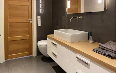 a bathroom with a sink and a toilet at Cozy Apartment In Gurskøy With Sauna in Kjellsund