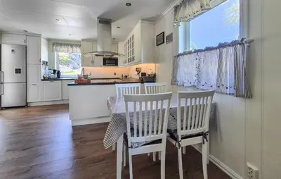 a kitchen with a table and two chairs and a counter at Amazing Home In Rubbestadneset With Wifi in Rubbestadneset