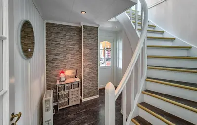 a hallway with stairs and a brick wall at Amazing Home In Rubbestadneset With Wifi in Rubbestadneset