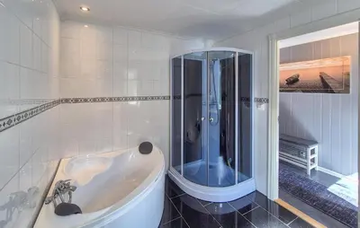 a white bathroom with a tub and a shower at Amazing Home In Rubbestadneset With Wifi in Rubbestadneset
