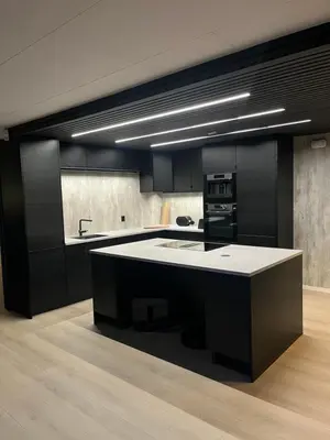 a kitchen with black cabinets and a white counter top at Stort hus i Steinkjer in Steinkjer