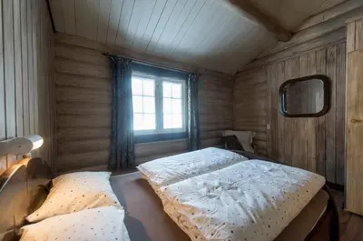 a bedroom with a bed and a window at Tveitehaug cabin, 3-4 bedroom cabin close to ski center in Ål