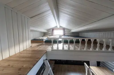 a small room with a bed and a staircase at Tveitehaug cabin, 3-4 bedroom cabin close to ski center in Ål