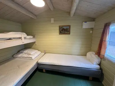 a small room with two beds and a window at Bjorliheimen Fjellhotell-Hytte 6 in Bjorli