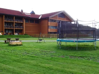 a large building with a playground in the grass at Actif 413 - apartment close to Ål Ski Centre in Ål