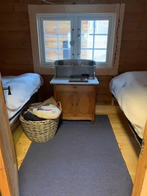 a room with a sink in a room with two beds at Log Cabin With Panoramic Views Of Hallingskarvet in Holo