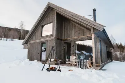 a small cabin in the snow with skis in front at Cabin at Norefjell ski resort, nice view in Noresund