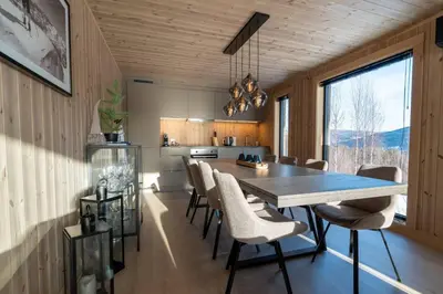 a kitchen and dining room with a table and chairs at Cabin at Norefjell ski resort, nice view in Noresund