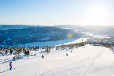 a group of people skiing down a snow covered slope at Cabin at Norefjell ski resort, nice view in Noresund