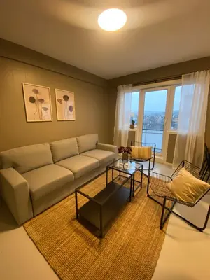 a living room with a couch and a table at Dronningens Gate 95, H0301 in Lii