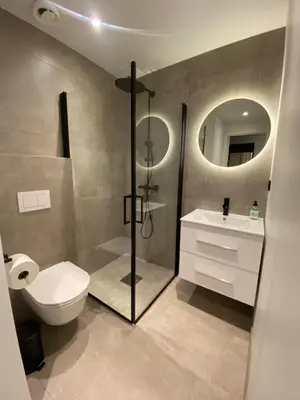 a bathroom with a toilet and a shower and a sink at Dronningens Gate 95, H0301 in Lii