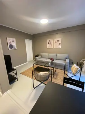 a living room with a couch and a table at Dronningens Gate 95, H0301 in Lii