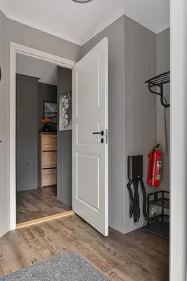 a room with a white door and a fire extinguisher at Fagerasen 790D by Vacation Trysil in Trysil