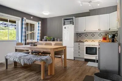 a kitchen with a wooden table and a dining room at Fagerasen 790D by Vacation Trysil in Trysil