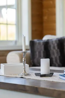 a candle on top of a table with a candle holder at Solsiden 16B by Vacation Trysil in Trysil