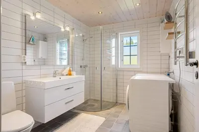 a bathroom with a toilet and a sink and a shower at Solsiden 16B by Vacation Trysil in Trysil