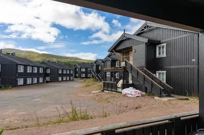 a row of houses in a parking lot at Fagerasen 760B by Vacation Trysil in Trysil