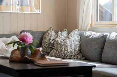 a living room with a couch with pillows and a table at Fagerasen 760B by Vacation Trysil in Trysil