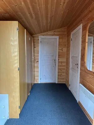 a room with two doors in a cabin at Bjorliheimen Fjellhotell-Hytte 9 in Bjorli
