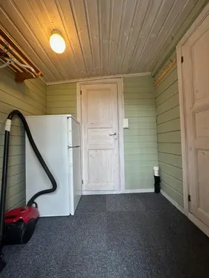 a room with a white refrigerator and a door at Bjorliheimen Fjellhotell-Hytte 10 & 17 in Bjorli