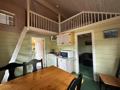 a kitchen and dining room with a table in a house at Bjorliheimen Fjellhotell-Hytte 10 & 17 in Bjorli