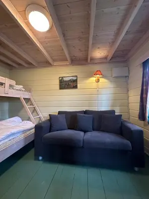 a living room with a couch and a bunk bed at Bjorliheimen Fjellhotell-Hytte 10 & 17 in Bjorli