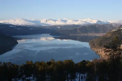 a view of a lake with snow covered mountains at Panorama by the fjord - Stryn in Stryn