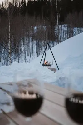 a person sitting in a swing in the snow at Spacious lodge with sauna, ski centre in Noresund