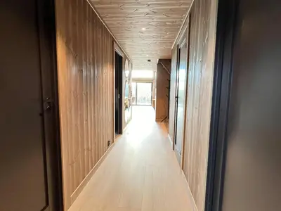 a hallway with wood paneling and a long hallway with a hallway at Spacious lodge with sauna, ski centre in Noresund