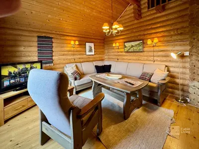 a living room with a couch and a table at Beitostølen Cabin - Sauna, large terrace and BBQ in Beitostøl