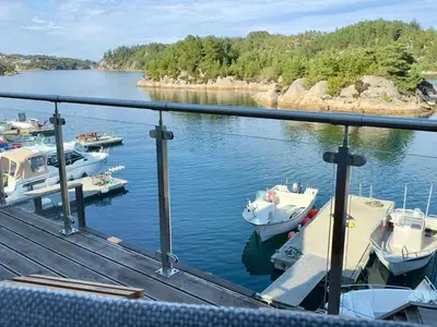 a group of boats docked at a dock in the water at 8 person holiday home in Urangsvåg in Ervik