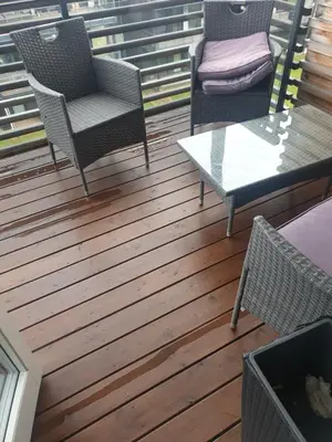 two chairs and a table on a deck at Modern apartment in Trondheim