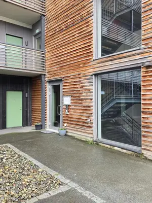 an empty parking lot in front of a brick building at Modern apartment in Trondheim