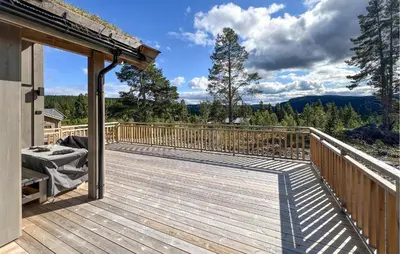 a wooden deck with a view of the mountains at Awesome Home In Gålå With Sauna in Gålå
