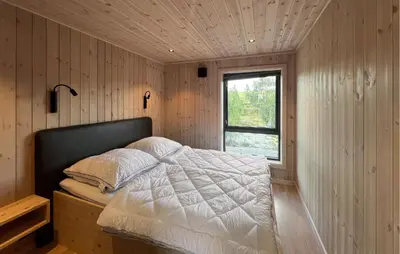 a bed in a small room with a window at Awesome Home In Gålå With Sauna in Gålå