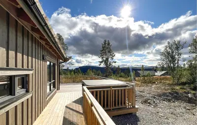 a porch of a house with the sun in the sky at Awesome Home In Gålå With Sauna in Gålå