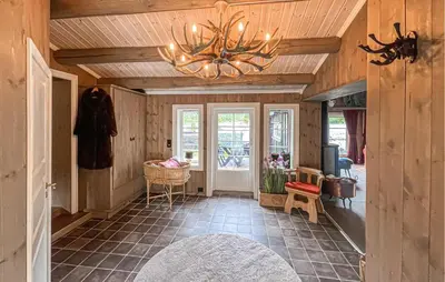a hallway with a chandelier in a house at 4 Bedroom Cozy Home In Nordberg in Nordberg