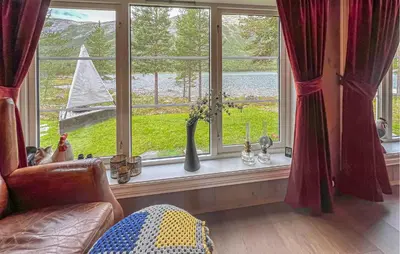 a living room with a window with vases on a window sill at 4 Bedroom Cozy Home In Nordberg in Nordberg