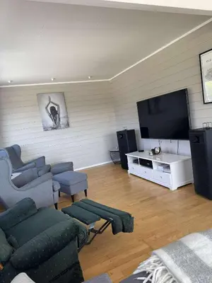 a living room with a couch and a flat screen tv at Korssundvegen 230 in Korssund