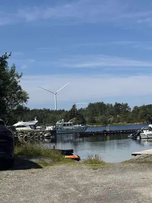 a marina with a wind turbine in the background at Korssundvegen 230 in Korssund