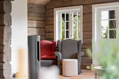 a living room with two chairs and a tv at Trysilfjell 811 by Vacation Trysil in Trysil