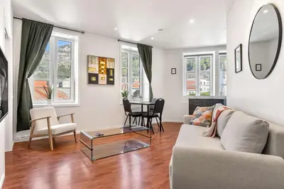 a living room with a couch and a table at Harbour - 1BR Apartment in Bergen