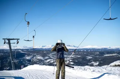 a man standing on top of a ski lift at Skogsbu - Stylish, Close to Ski centers and hiking trails in Nesbyen